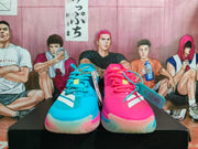 Front view of the blue and pink sneakers showing white side stripes, colored laces, and translucent-looking toe soles.