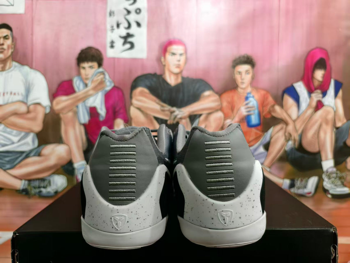 Rear view of gray and white Kobe basketball shoes with speckled midsoles