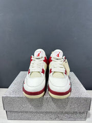 Front view of the pair showing white laces, red accents, cream mesh, and tongue logos.