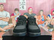 Front view of the pair of black basketball sneakers showing the laces, perforated toe panels, padded tongues, and low-contrast emblems.