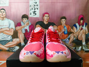 Front view showing the pink toe panels, multicolor heart print, and red laces.