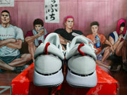 Rear view of the pair showing white heel panels, padded collars, red pull tabs, and the textured outsole edges.