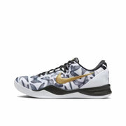 White Kobe 8 sneaker with gray graphic panels, gold Swoosh and black midsole detail.
