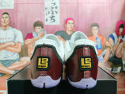 Rear view of white and red Nike-style basketball shoes with black and gold heel details