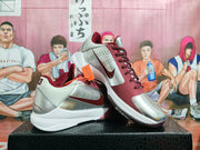 Angled side view showing the contrasting Nike swoosh, perforated panels, burgundy forefoot, and white midsole.
