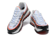 Nike sneakers shown from the front and above, with white uppers, black toe sections, and orange accents.