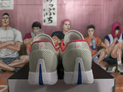 Rear view of the sneakers showing textured heel panels, pink heel logos, and blue outsole inserts.