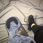 Close-up of the outsole showing translucent blue-gray sections and black traction areas.