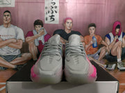 Front view of the pair showing gray toe boxes, laces, pink accents, and translucent-looking outsole sections.