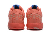 Rear view of the coral sneakers showing padded collars, patterned panels, silver accents, and vertical SESDONA lettering.