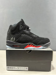 Side view of a black Air Jordan 5 sneaker on its box; the box label shows USA 8.5, EURO 42, UK 7.5, and CM 26.5.