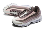 Pair of layered brown and pink Nike sneakers shown from above and at an angle.