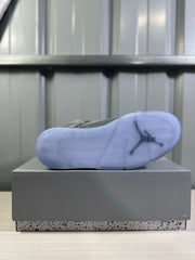 Bottom view showing the translucent blue outsole and its tread pattern.