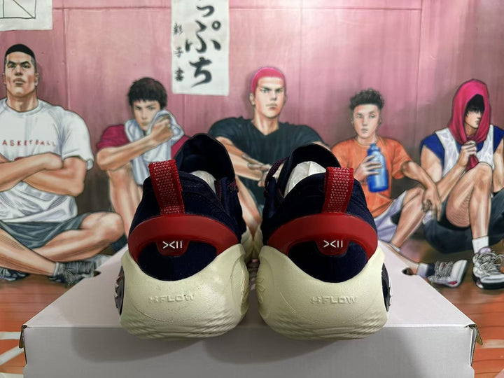 Rear view of navy basketball shoes with red heel details and cream soles