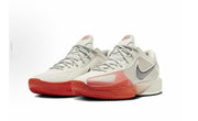 Pair of Nike G.T Cut Cross EP sneakers in white, gray, and red-pink with perforated panels and textured outsoles.