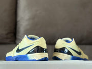 Rear view of the pair showing the glossy black heel panels and blue outsole accents.
