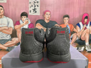 Rear view of grey and red Nike basketball sneakers showing padded collars, stitched heel panels and red outsole accents.