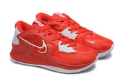 Angled view of the red and white Nike Kyrie shoes