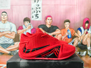 Side profile of a red basketball shoe with black graphic accents.