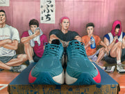 Front view of teal Brooks Hyperion Max running shoes with teal laces and pink heel accents