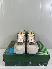 Front view of the pair showing cream laces, green lace supports, mesh panels and tan tongue labels.