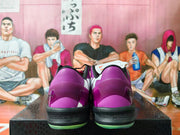 Rear view showing purple heels, black heel cushioning, and green outsole details.