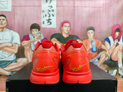 Rear view of the red sneakers showing translucent heel panels and signature-style graphics.