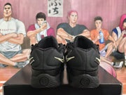 Rear view of black Nike KD 4 sneakers showing light-colored heel Swooshes.