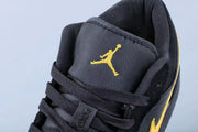 Close-up of the black tongue with a yellow Jordan logo and black laces.