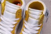 Top view showing padded white tongues, white laces, and yellow eyelet overlays.
