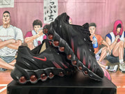 Black Nike Air Max sneakers shown from the side with dark red accents and podded soles