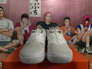 Front view of the white Nike sneaker pair showing the lace-up design, textured toe panels, and patterned outsoles.
