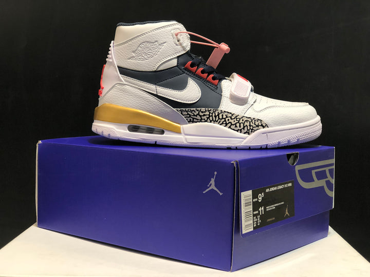Side view of a Jordan Air Jordan Legacy 312 sneaker displayed on its shoe box, showing the white, navy, gold and red color scheme.