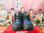 Front view of the black and blue Nike Air Destrukt sneakers, showing the laces, padded tongues, and toe detailing.