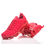 Pair of red Nike sneakers, including an outsole view.