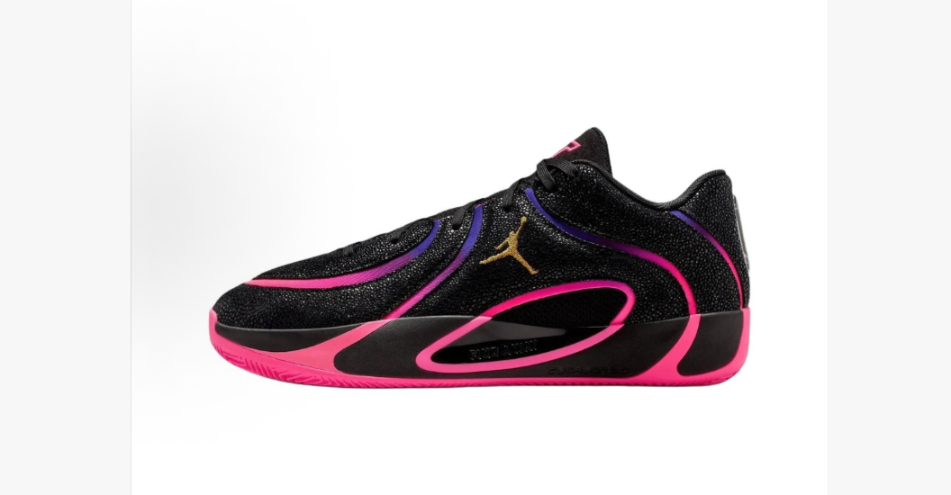Side view of black Jordan basketball sneakers with pink and purple detailing, a gold Jumpman logo, and a pink outsole.