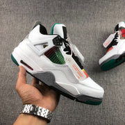 Handheld side profile showing the white upper, multicolor mesh, grey speckled midsole, green outsole, and heel Air window.