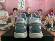 Rear view showing the padded collars, grey heel panels, blue detailing and cushioned-looking outsoles.