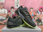 Pair of black Nike basketball shoes with speckled heels and bright green outsoles