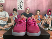 Front view of pink lace-up basketball shoes with pale accents and light-colored soles.