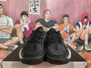 Front view of the black Nike basketball shoes showing the lace-up design, black toe boxes, and contrasting outsole edges.