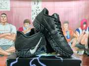 Pair of black Nike LeBron shoes shown from side and front angles
