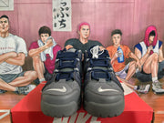 Front view of navy and gray Nike high-top sneakers showing laces, perforated panels, and contrasting toe Swoosh branding.