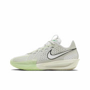 Side view of a predominantly white Nike GT Cut 3 sneaker with black Swoosh detailing and pale green translucent outsole accents.