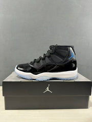 Side profile of a black high-top sneaker with blue branding, a white midsole and translucent blue outsole.