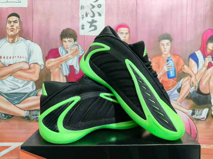 Pair of black basketball shoes with neon-green accents shown at an angle.