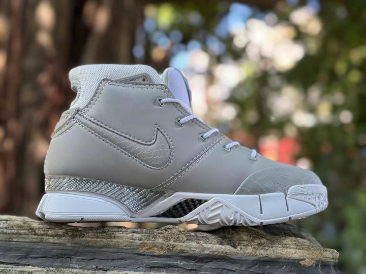 Side view of a grey and white Nike Kobe 1 FTB high-top shoe