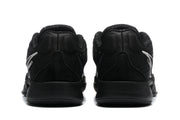 Rear view of the black sneakers showing padded collars, heel construction, and white side branding.