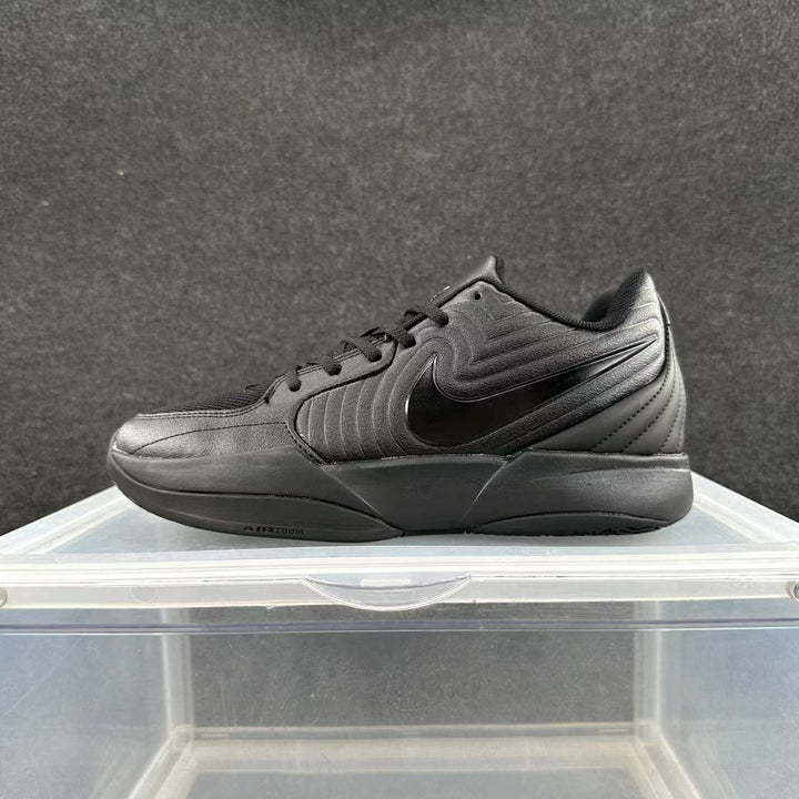 Side view of an all-black Nike low-top sneaker with a lace-up closure, side Swoosh, and Air Zoom midsole branding.