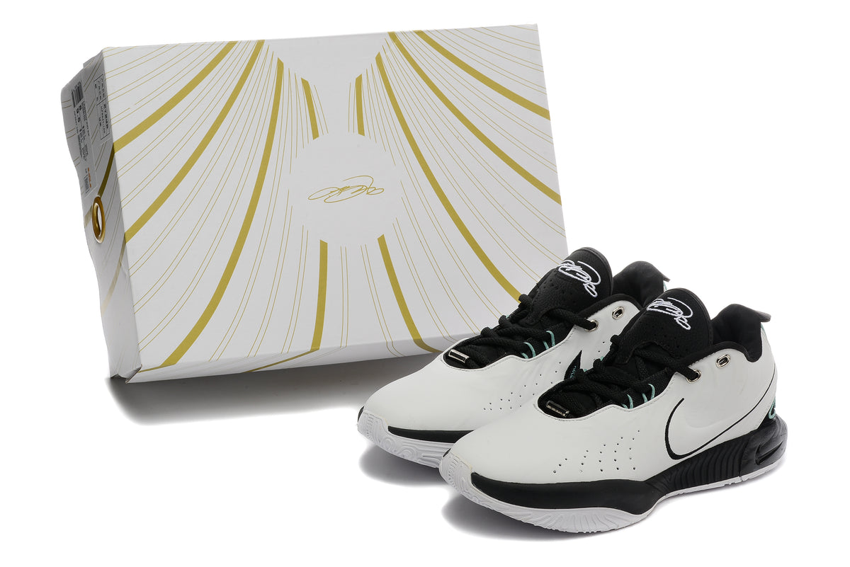 Pair of white and black Nike basketball sneakers beside a white-and-gold box